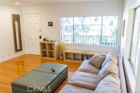 living area with wood finished floors and baseboards