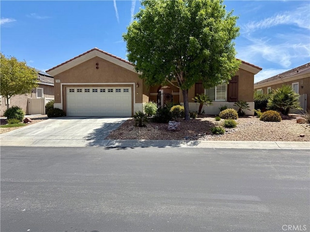 10485 Nobleton Rd, Apple Valley, CA 92308 - view of front of house with stucco siding, an attached garage, and concrete driveway