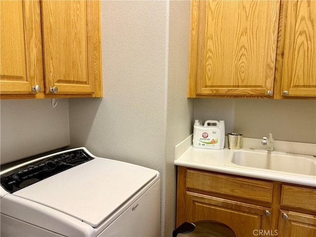 10485 Nobleton Rd, Apple Valley, CA 92308 - washroom featuring a textured wall, washer / dryer, cabinet space, and a sink
