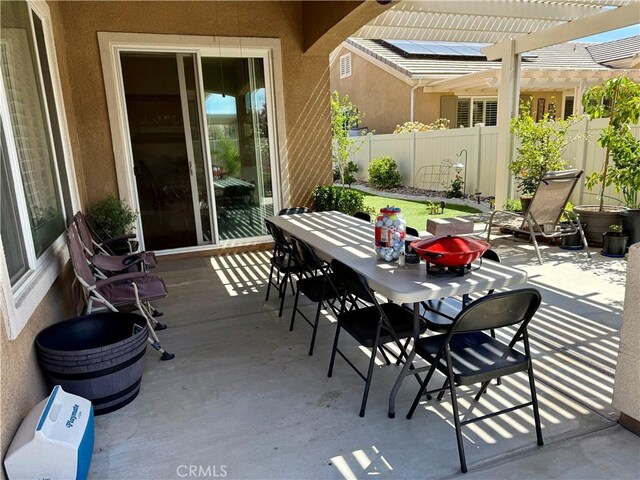 10485 Nobleton Rd, Apple Valley, CA 92308 - view of patio featuring fence, outdoor dining space, and a pergola