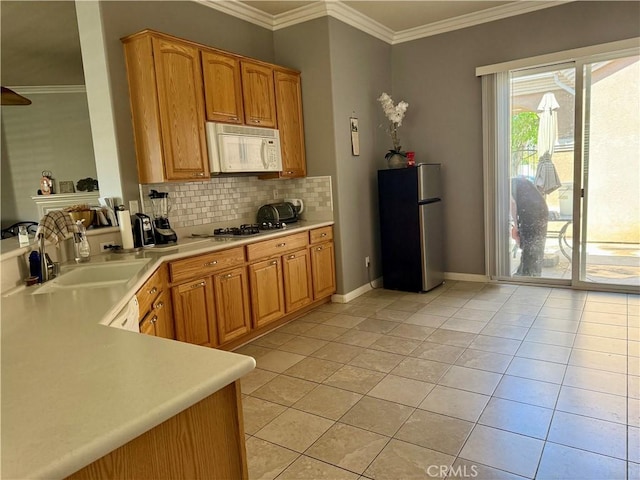 10485 Nobleton Rd, Apple Valley, CA 92308 - kitchen with a sink, light tile patterned flooring, light countertops, backsplash, and appliances with stainless steel finishes