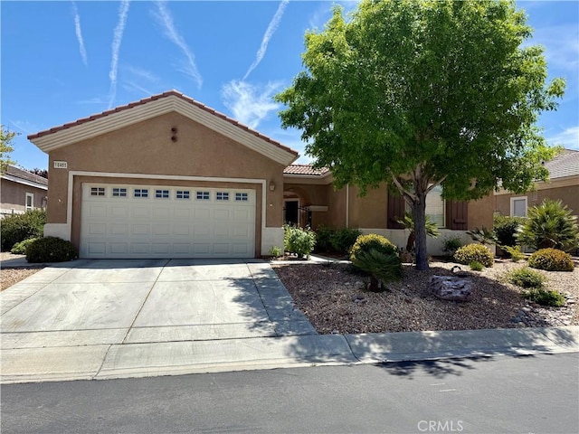 10485 Nobleton Rd, Apple Valley, CA 92308 - ranch-style home featuring a garage, concrete driveway, a tiled roof, and stucco siding