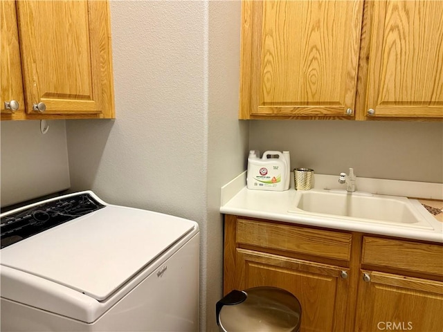 10485 Nobleton Rd, Apple Valley, CA 92308 - laundry room featuring washer / dryer, a textured wall, cabinet space, and a sink