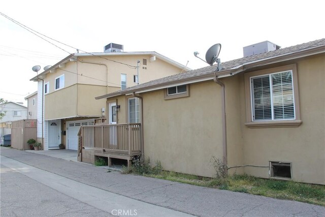 view of property exterior with stucco siding and an attached garage