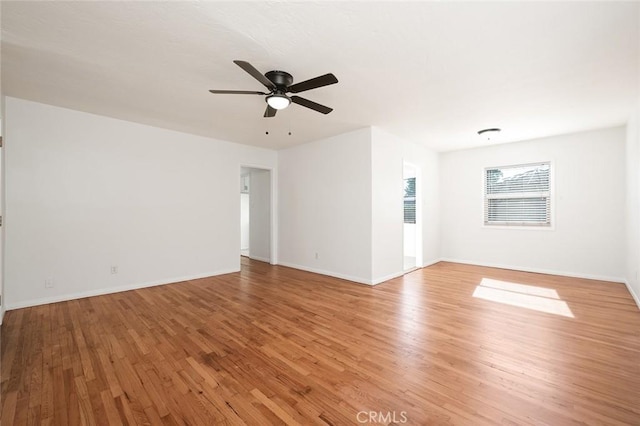 unfurnished room with baseboards, light wood-style flooring, and ceiling fan