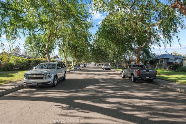 view of road with sidewalks and curbs