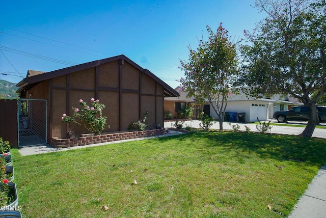view of front of property with driveway, an attached garage, and a front lawn