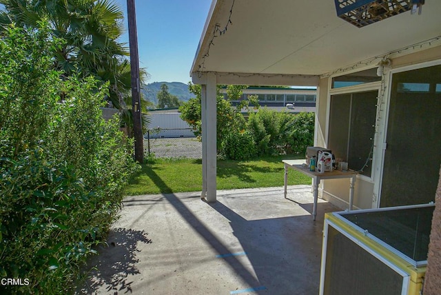 view of patio / terrace with a mountain view and fence