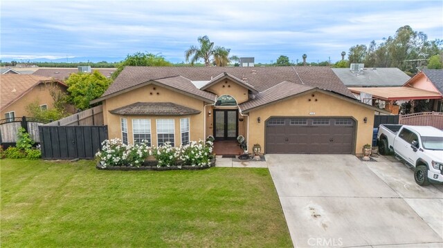 single story home featuring a front lawn, stucco siding, french doors, an attached garage, and driveway