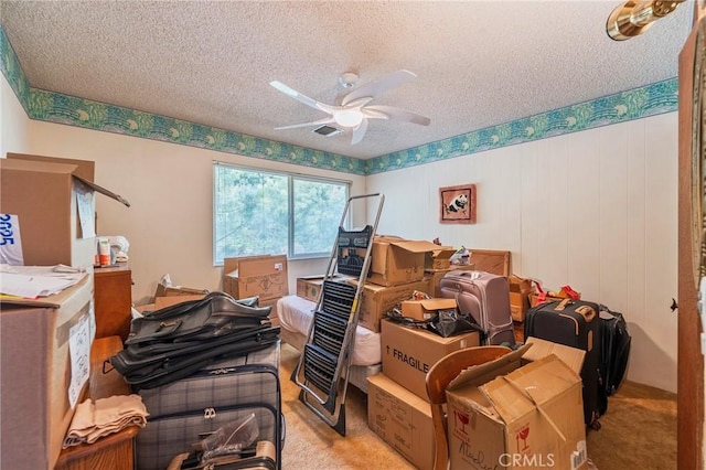 bedroom featuring a textured ceiling, visible vents, and light colored carpet