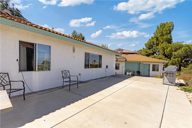 11485 Crafton, Mentone, CA 92359 - rear view of property featuring stucco siding, a patio area, and a tile roof