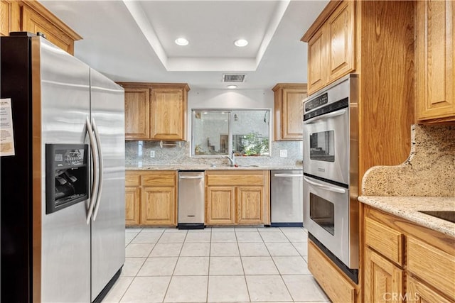 11485 Crafton, Mentone, CA 92359 - kitchen featuring stainless steel appliances, a tray ceiling, backsplash, light tile patterned floors, and recessed lighting