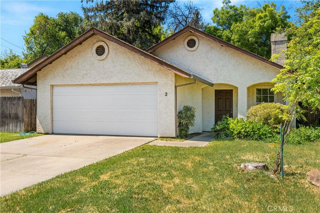 2 Hunter Ct, Chico, CA 95928 - view of front of house featuring driveway, fence, an attached garage, a front yard, and stucco siding