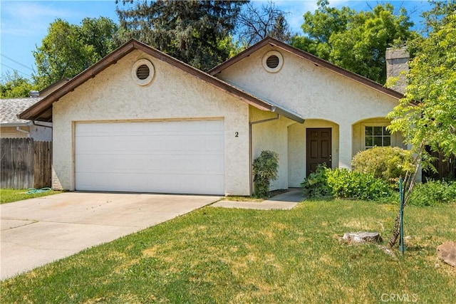 2 Hunter Ct, Chico, CA 95928 - view of front of house featuring driveway, fence, an attached garage, a front yard, and stucco siding