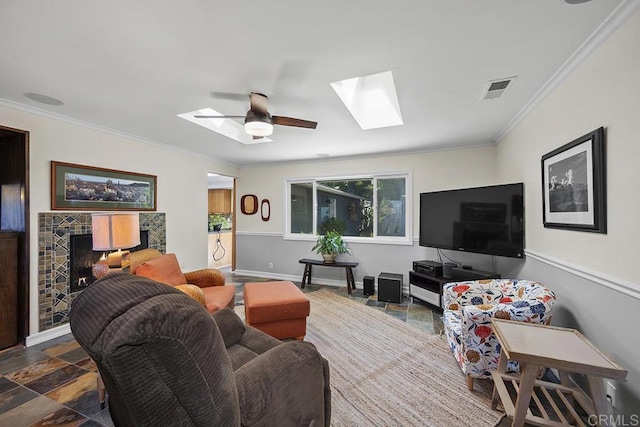2406 Mcdougal Pl, Alpine, CA 91901 - living room with a skylight, ornamental molding, stone finish floors, ceiling fan, and a tile fireplace