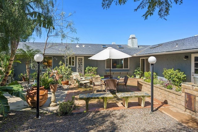 2406 Mcdougal Pl, Alpine, CA 91901 - back of house featuring a patio, stucco siding, a chimney, roof with shingles, and outdoor dining area