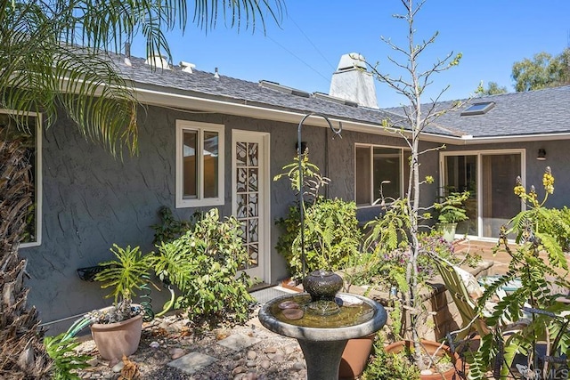 2406 Mcdougal Pl, Alpine, CA 91901 - property entrance featuring stucco siding, a chimney, and a shingled roof