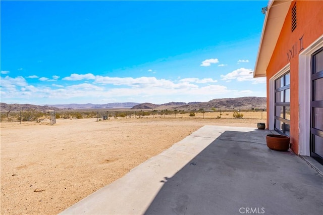 55850 Shannon Rd, Landers, CA 92285 - view of yard with a mountain view, a patio area, and a rural view