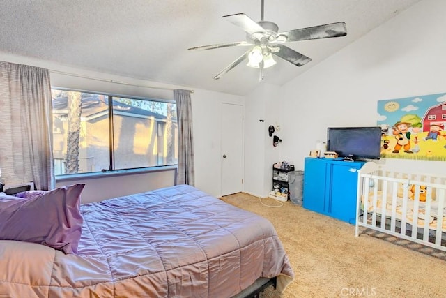 bedroom featuring a textured ceiling, ceiling fan, vaulted ceiling, and carpet