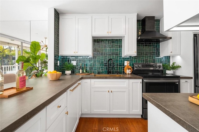 1400 N Sweetzer Ave Unit 102, West Hollywood, CA 90069 - kitchen with a sink, black electric range oven, wall chimney exhaust hood, dark countertops, and white cabinets