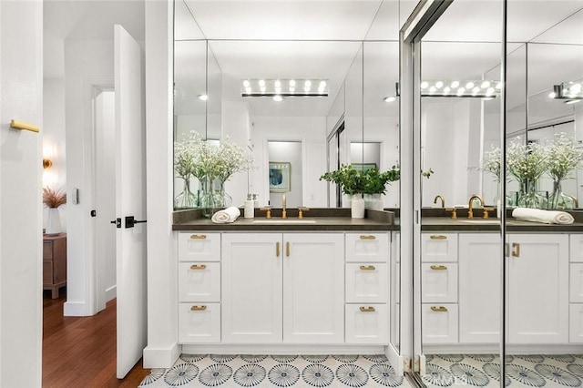1400 N Sweetzer Ave Unit 102, West Hollywood, CA 90069 - bathroom with vanity, wood finished floors, and baseboards
