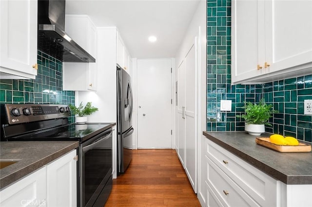 1400 N Sweetzer Ave Unit 102, West Hollywood, CA 90069 - kitchen with electric stove, wall chimney exhaust hood, stainless steel fridge, dark countertops, and tasteful backsplash