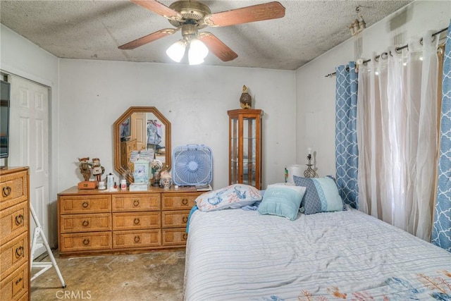 bedroom with ceiling fan, carpet flooring, and a textured ceiling