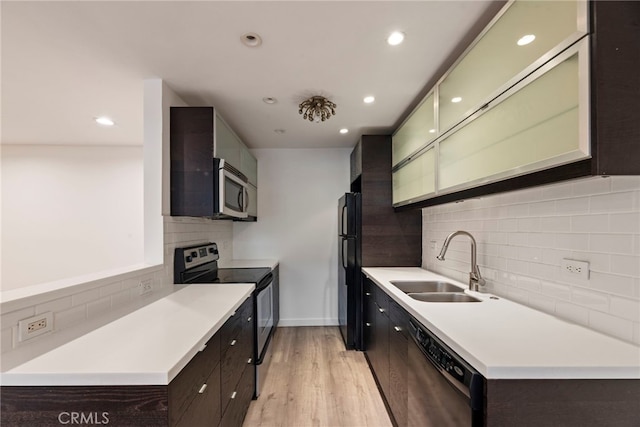 525 N Sycamore Ave Unit 333, Los Angeles, CA 90036 - kitchen with black appliances, tasteful backsplash, dark brown cabinets, light countertops, and light wood-type flooring
