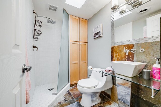 800 E Cottonwood Rd Unit 2, Palm Springs, CA 92262 - full bathroom featuring a stall shower, a skylight, toilet, a sink, and stone finish flooring