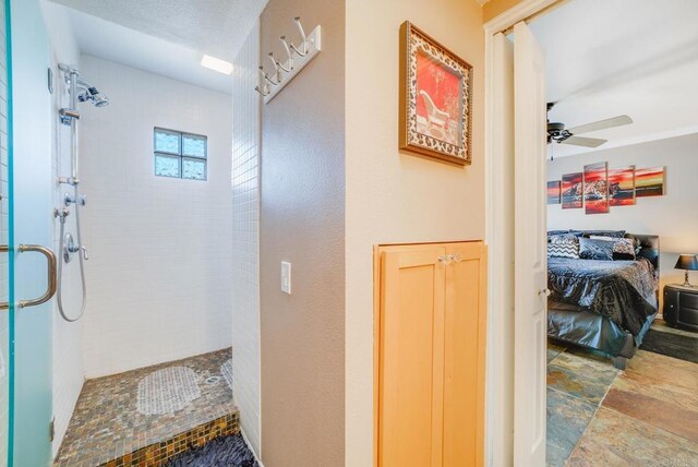 800 E Cottonwood Rd Unit 2, Palm Springs, CA 92262 - bathroom with a stall shower, ensuite bathroom, a ceiling fan, and stone finish flooring