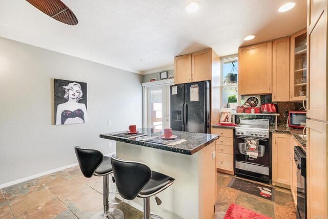 800 E Cottonwood Rd Unit 2, Palm Springs, CA 92262 - kitchen featuring black fridge with ice dispenser, light brown cabinetry, range, dark countertops, and recessed lighting