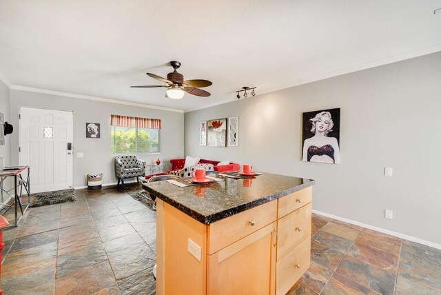 800 E Cottonwood Rd Unit 2, Palm Springs, CA 92262 - kitchen featuring stone tile floors, light brown cabinets, crown molding, a center island, and ceiling fan