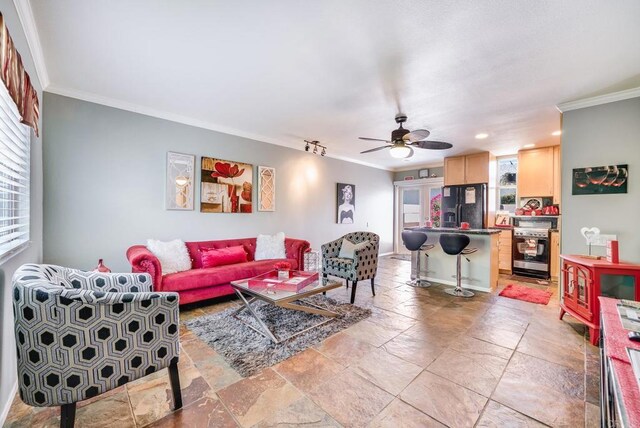 800 E Cottonwood Rd Unit 2, Palm Springs, CA 92262 - living room with crown molding, stone tile floors, ceiling fan, recessed lighting, and baseboards