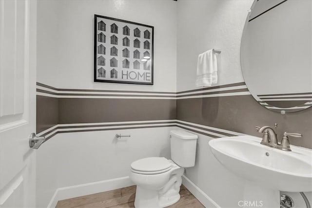2219 W Malone St, Hanford, CA 93230 - bathroom featuring wood finished floors, toilet, and a sink