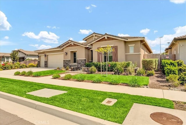 2219 W Malone St, Hanford, CA 93230 - craftsman inspired home featuring fence, an attached garage, a front yard, and stucco siding