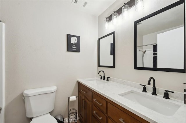 10616 Jamul Rd, Apple Valley, CA 92308 - bathroom featuring double vanity, visible vents, toilet, and a sink