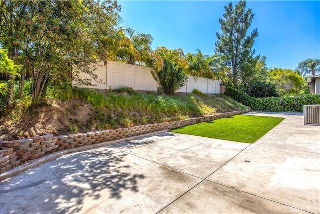 6356 Claridge Dr, Riverside, CA 92506 - view of yard featuring central AC unit, a fenced backyard, and a patio area