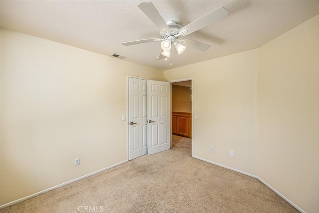 6356 Claridge Dr, Riverside, CA 92506 - unfurnished bedroom featuring light colored carpet, baseboards, ceiling fan, and visible vents