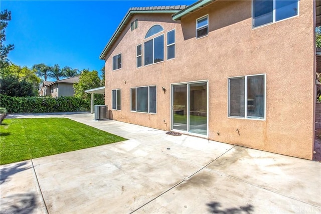 6356 Claridge Dr, Riverside, CA 92506 - back of house featuring a lawn, a patio, central AC unit, and stucco siding