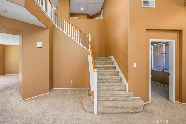 6356 Claridge Dr, Riverside, CA 92506 - stairway with carpet floors, baseboards, a towering ceiling, and visible vents