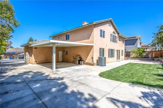 6356 Claridge Dr, Riverside, CA 92506 - back of property featuring driveway, central AC unit, a carport, fence, and stucco siding