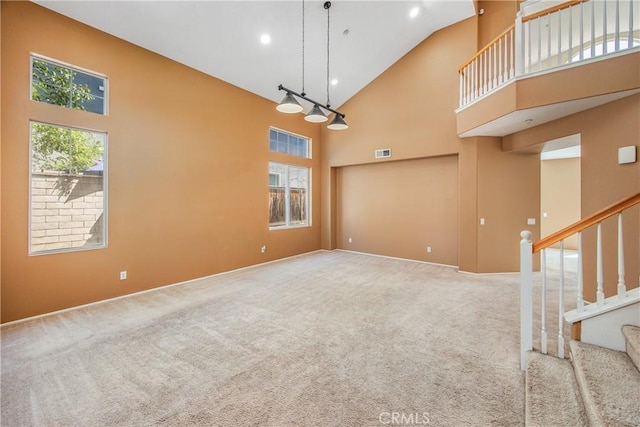 6356 Claridge Dr, Riverside, CA 92506 - spare room featuring visible vents, carpet flooring, high vaulted ceiling, and stairway