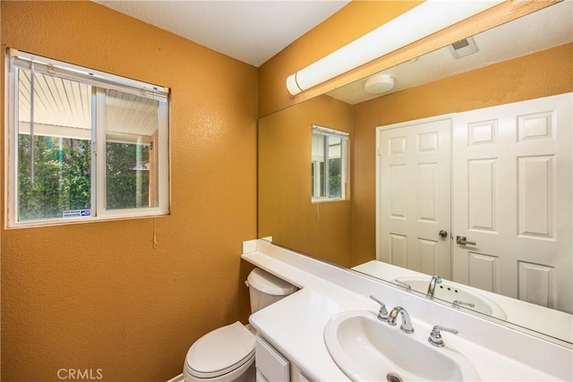 6356 Claridge Dr, Riverside, CA 92506 - half bath with vanity, a textured wall, and toilet