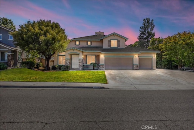 6356 Claridge Dr, Riverside, CA 92506 - traditional home featuring driveway, a front yard, an attached garage, stone siding, and stucco siding