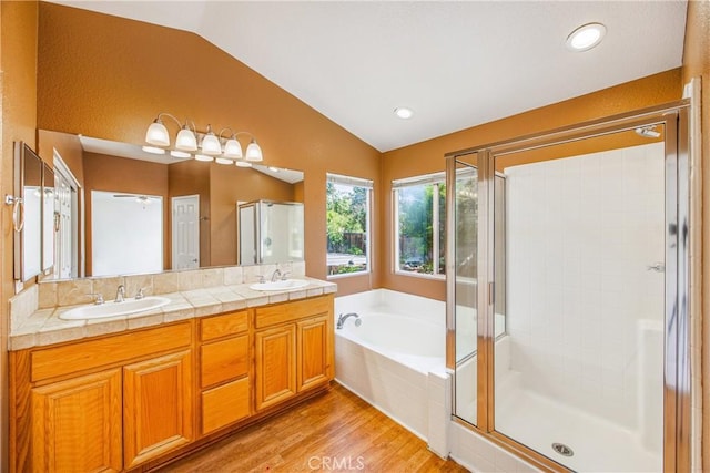6356 Claridge Dr, Riverside, CA 92506 - full bath featuring a sink, wood finished floors, lofted ceiling, a garden tub, and a stall shower