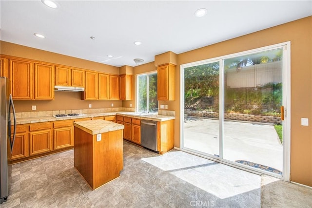 6356 Claridge Dr, Riverside, CA 92506 - kitchen with a center island, under cabinet range hood, tile counters, stainless steel appliances, and recessed lighting
