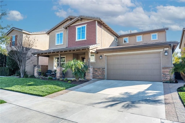 craftsman-style home with a front lawn, stucco siding, concrete driveway, stone siding, and a porch