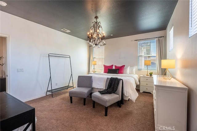 bedroom featuring a chandelier, visible vents, and carpet