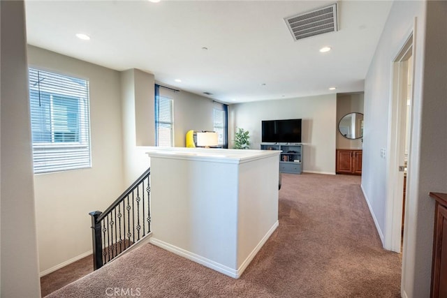 hallway featuring baseboards, recessed lighting, visible vents, an upstairs landing, and carpet floors
