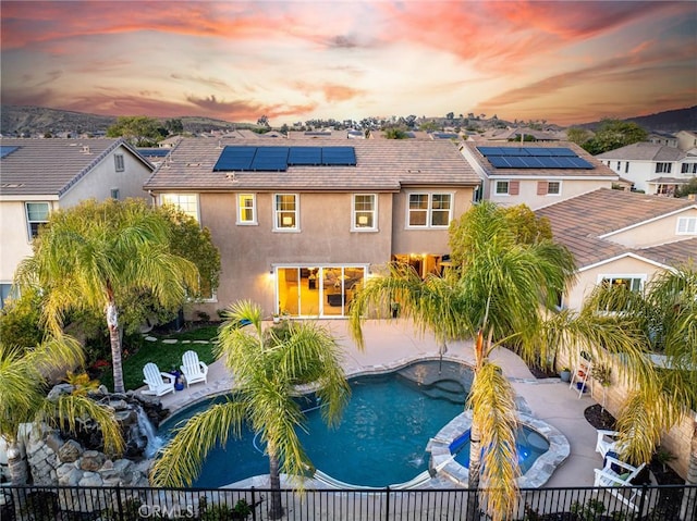 22514 Brightwood Pl, Saugus, CA 91350 - rear view of property featuring stucco siding, a fenced backyard, and a pool with connected hot tub